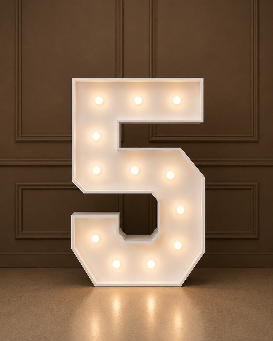 A large illuminated marquee letter '5' in white, lit with warm white bulbs, set against a dark brown paneled wall and floor.