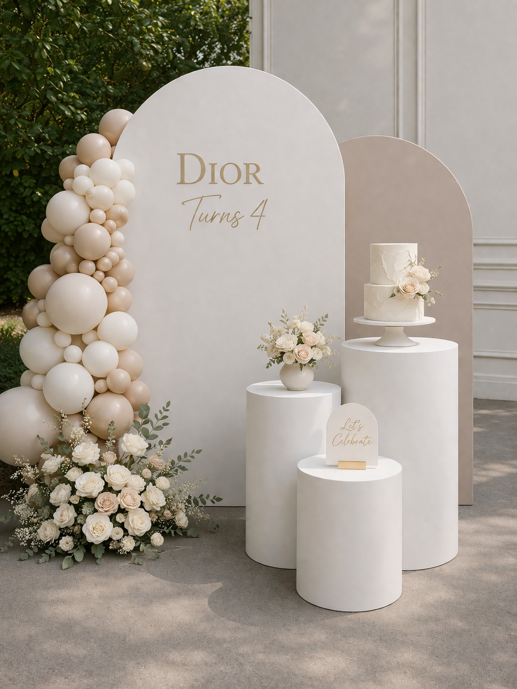 Decorative setup with balloons, flowers, and a cake against a Dior branded backdrop.